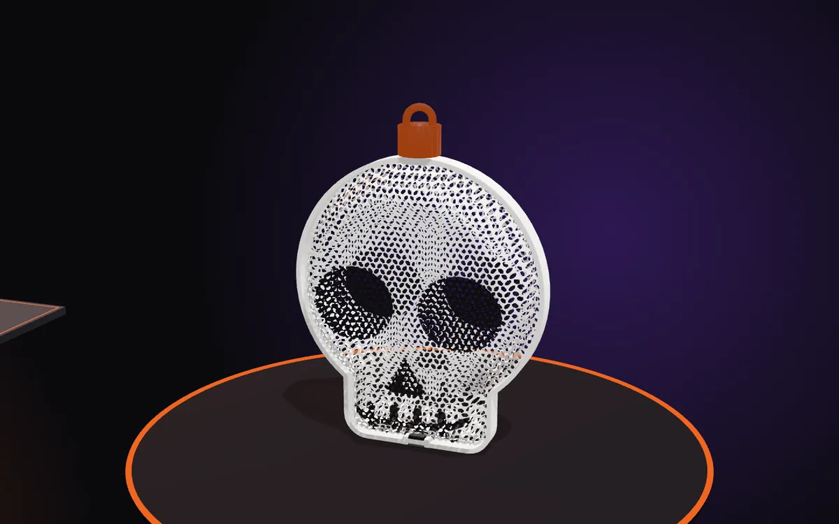 The closed skull ornament with the nut and its hanging loop on top